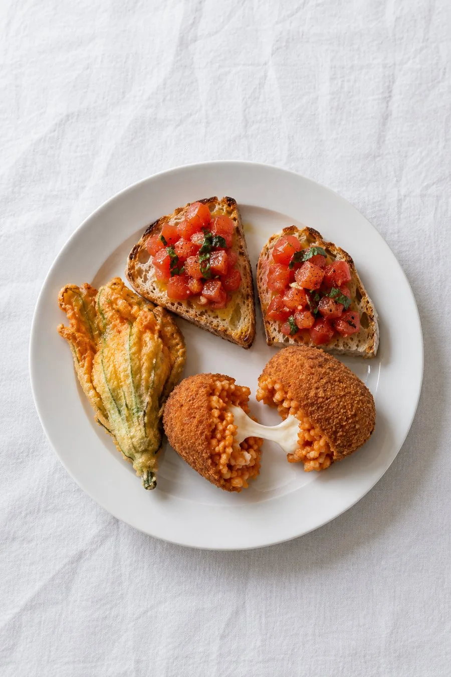 Roman starters: suppli, courgette flowers and tomato bruschetta